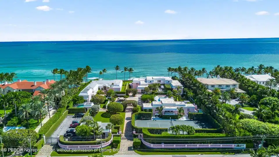Aerial view of luxury Palm Beach, FL homes with lush landscaping and oceanfront views along the coastline.